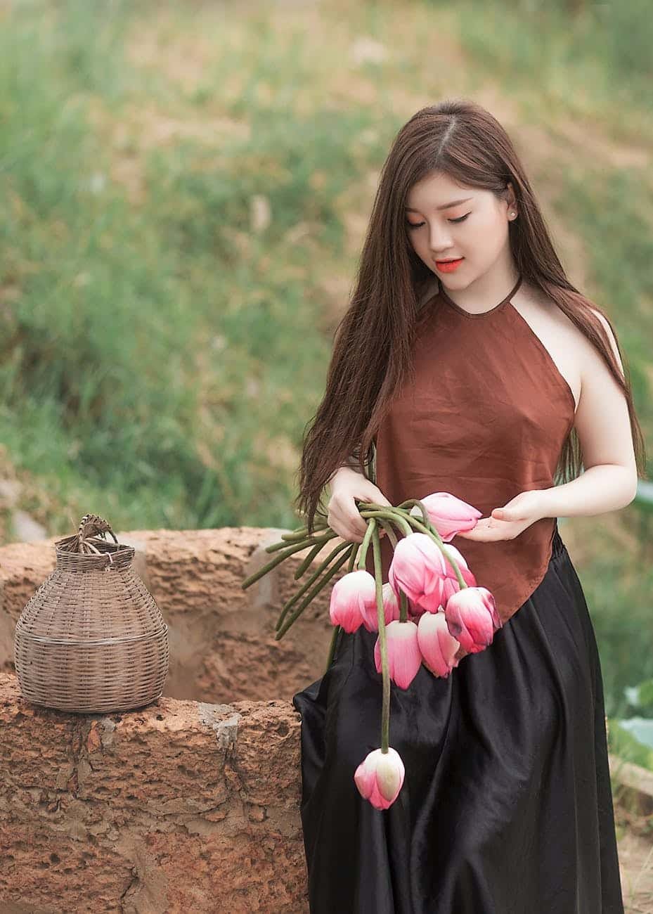 woman holding pink tulips